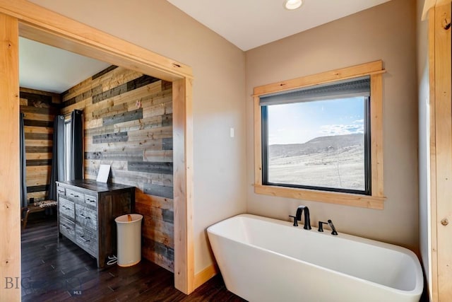 251 Fawn Mdw, Manhattan, MT 59741 - full bathroom with wooden walls, a soaking tub, wood finished floors, and baseboards