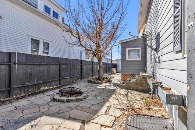 view of patio / terrace with a fenced backyard and a fire pit