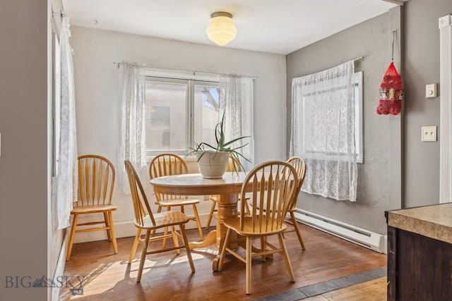 dining room featuring hardwood / wood-style floors and baseboard heating