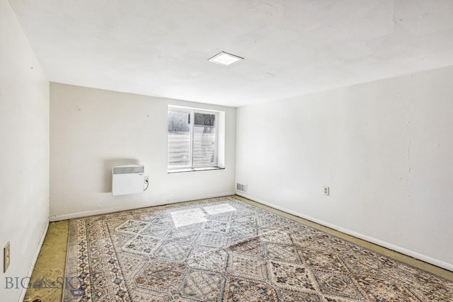 empty room with baseboards and visible vents