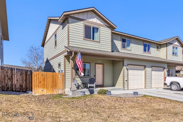 1009 Idaho Unit B, Belgrade, MT 59714 - view of front of property with driveway, board and batten siding, fence, a garage, and a porch