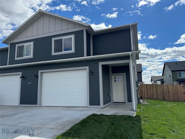 2000 Blackhawk Ln Unit B, Belgrade, MT 59714 - view of front facade with a garage, concrete driveway, and board and batten siding