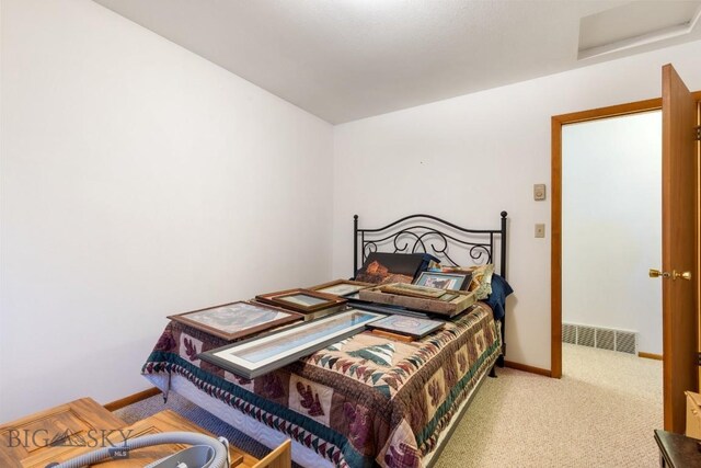 490 Secretariat Cir, Belgrade, MT 59714 - carpeted bedroom with baseboards, attic access, and visible vents