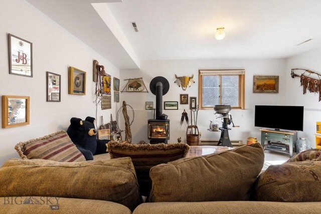 490 Secretariat Cir, Belgrade, MT 59714 - living room featuring visible vents and a wood stove