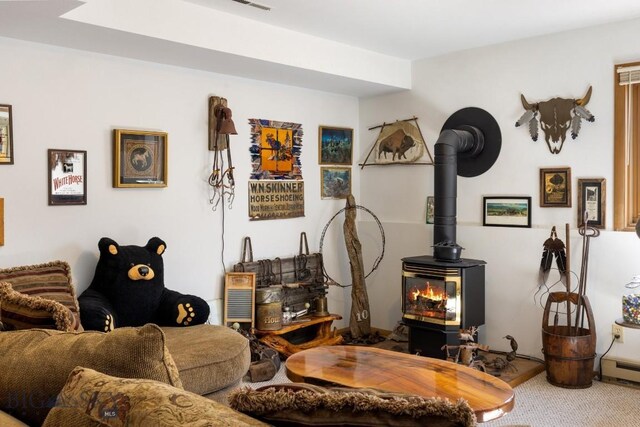 490 Secretariat Cir, Belgrade, MT 59714 - living area featuring carpet floors and a wood stove