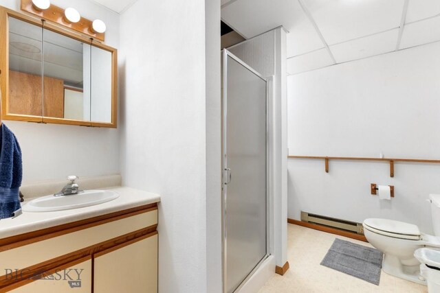 490 Secretariat Cir, Belgrade, MT 59714 - bathroom featuring vanity, a stall shower, baseboard heating, and toilet
