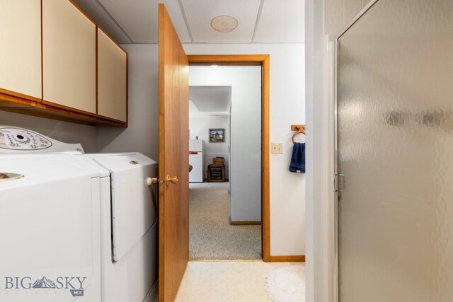 490 Secretariat Cir, Belgrade, MT 59714 - washroom featuring separate washer and dryer, cabinet space, baseboards, and light colored carpet