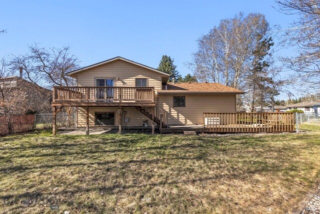 490 Secretariat Cir, Belgrade, MT 59714 - back of property featuring a yard, a wooden deck, stairs, and a fenced backyard