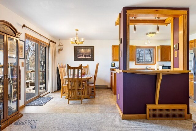 490 Secretariat Cir, Belgrade, MT 59714 - dining space featuring an inviting chandelier and baseboard heating
