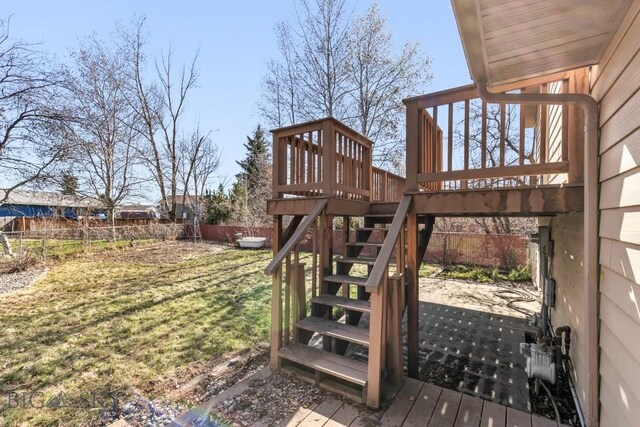 490 Secretariat Cir, Belgrade, MT 59714 - wooden deck with a lawn, a fenced backyard, and stairway