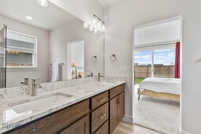 1510 Deadwood Loop, Belgrade, MT 59714 - bathroom featuring connected bathroom, double vanity, and wood finished floors