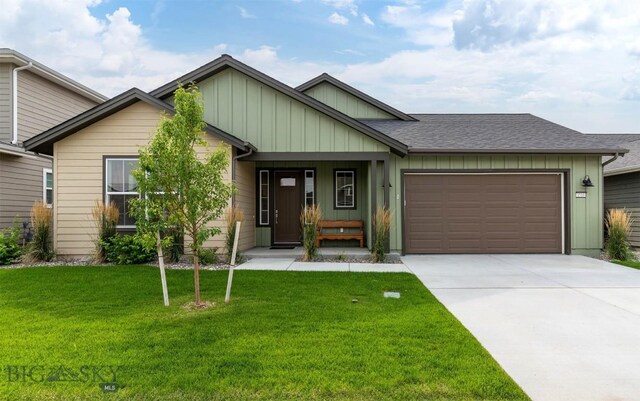 1510 Deadwood Loop, Belgrade, MT 59714 - view of front facade featuring an attached garage, driveway, a front yard, board and batten siding, and roof with shingles