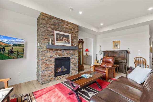 1510 Deadwood Loop, Belgrade, MT 59714 - living area featuring wood finished floors, a stone fireplace, and recessed lighting