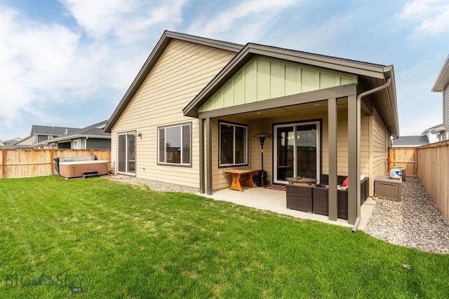 1510 Deadwood Loop, Belgrade, MT 59714 - back of house with a hot tub, board and batten siding, a patio, and a fenced backyard