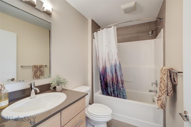 bathroom featuring shower / bath combo with shower curtain, vanity, and toilet