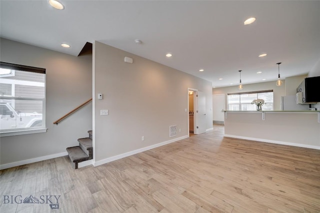 unfurnished living room with recessed lighting, stairway, visible vents, baseboards, and light wood-style flooring