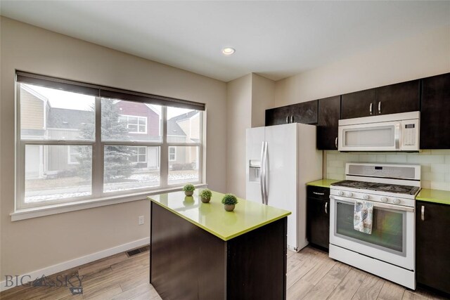 kitchen with visible vents, light countertops, white appliances, and light wood-style floors