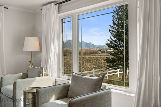 sitting room featuring a mountain view and ornamental molding