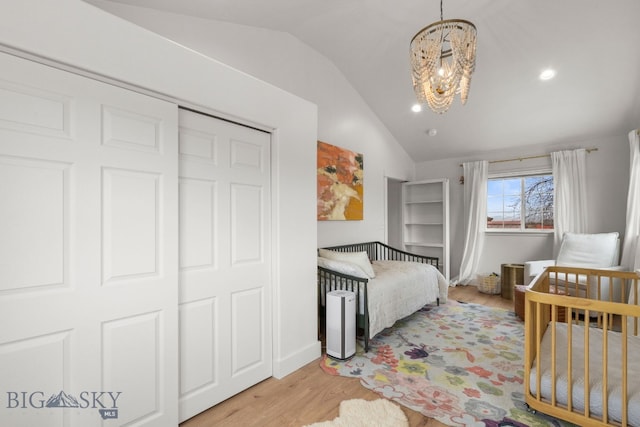 bedroom with light wood-style floors, a notable chandelier, lofted ceiling, and recessed lighting
