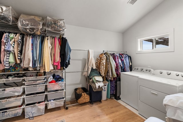 laundry area featuring visible vents, independent washer and dryer, light wood finished floors, and laundry area
