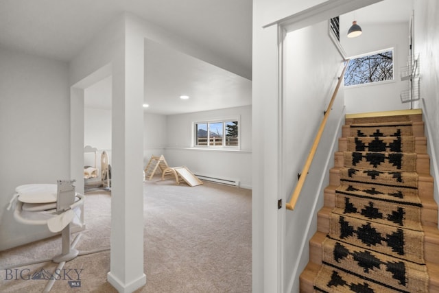 staircase featuring a baseboard heating unit, baseboards, carpet, and recessed lighting