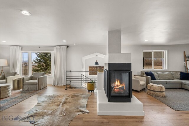 living area with recessed lighting and wood finished floors