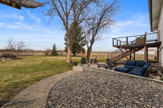 view of yard featuring a rural view, a patio, a wooden deck, and stairway
