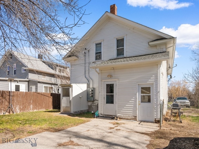 220 4th Ave E, Three Forks, MT 59752 - back of property with a yard, fence, and a chimney