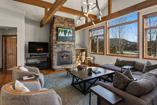 2430 Two Gun White Calf Rd, Big Sky, MT 59716 - living area featuring beamed ceiling, wood finished floors, a fireplace, baseboards, and high vaulted ceiling