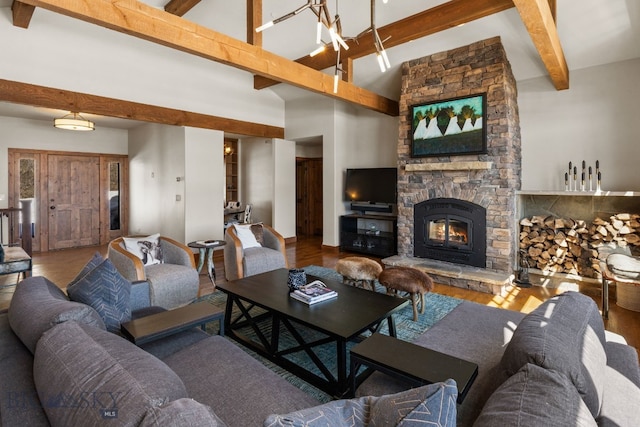2430 Two Gun White Calf Rd, Big Sky, MT 59716 - living area with beam ceiling, wood finished floors, a stone fireplace, and high vaulted ceiling