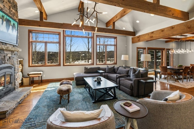 2430 Two Gun White Calf Rd, Big Sky, MT 59716 - living area with a chandelier, beam ceiling, wood finished floors, plenty of natural light, and recessed lighting