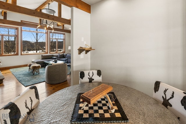 2430 Two Gun White Calf Rd, Big Sky, MT 59716 - dining space featuring a chandelier, wood finished floors, and baseboards