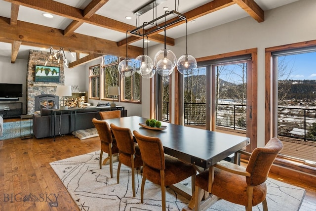 2430 Two Gun White Calf Rd, Big Sky, MT 59716 - dining space with beamed ceiling, hardwood / wood-style floors, coffered ceiling, a stone fireplace, and recessed lighting