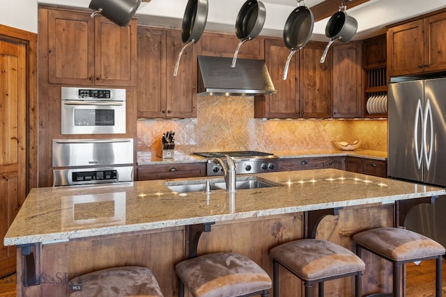 2430 Two Gun White Calf Rd, Big Sky, MT 59716 - kitchen with stainless steel appliances, ventilation hood, tasteful backsplash, and a sink