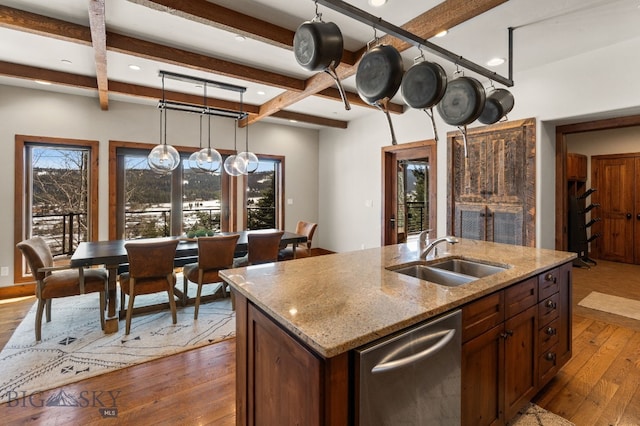 2430 Two Gun White Calf Rd, Big Sky, MT 59716 - kitchen featuring a sink, hardwood / wood-style floors, decorative light fixtures, light stone counters, and dishwasher