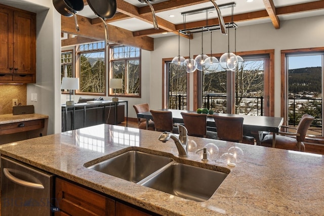 2430 Two Gun White Calf Rd, Big Sky, MT 59716 - kitchen featuring a sink, coffered ceiling, brown cabinets, beam ceiling, and plenty of natural light