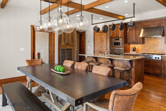 2430 Two Gun White Calf Rd, Big Sky, MT 59716 - dining area with beamed ceiling, dark wood-style flooring, recessed lighting, and baseboards
