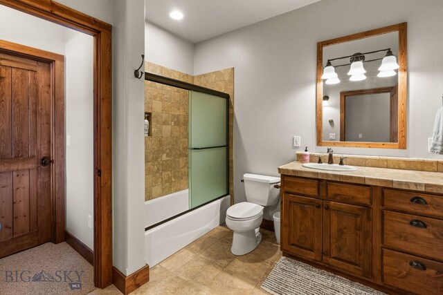 2430 Two Gun White Calf Rd, Big Sky, MT 59716 - bathroom with toilet, vanity, combined bath / shower with glass door, and baseboards