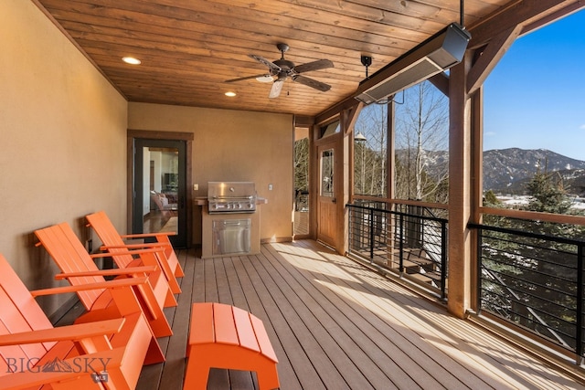 2430 Two Gun White Calf Rd, Big Sky, MT 59716 - wooden deck with area for grilling, a mountain view, and a ceiling fan