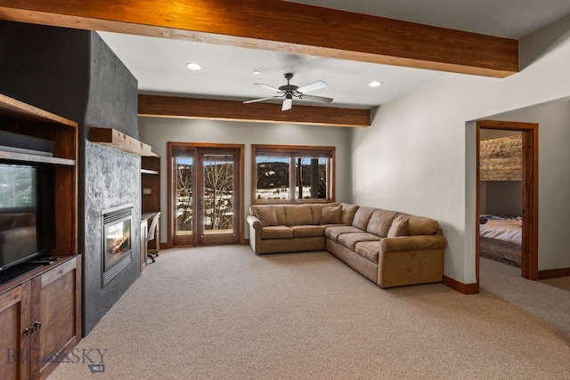 2430 Two Gun White Calf Rd, Big Sky, MT 59716 - living room with light colored carpet, a large fireplace, beam ceiling, recessed lighting, and baseboards