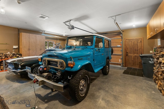 2430 Two Gun White Calf Rd, Big Sky, MT 59716 - garage featuring a garage door opener