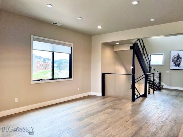 unfurnished living room featuring baseboards, recessed lighting, visible vents, and hardwood / wood-style floors