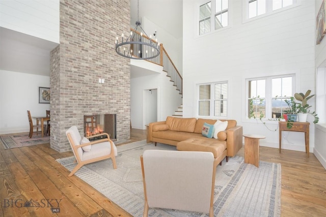 992 Deer Haven Dr, Deer Lodge, MT 59722 - living area featuring a high ceiling, hardwood / wood-style flooring, plenty of natural light, a chandelier, and baseboards
