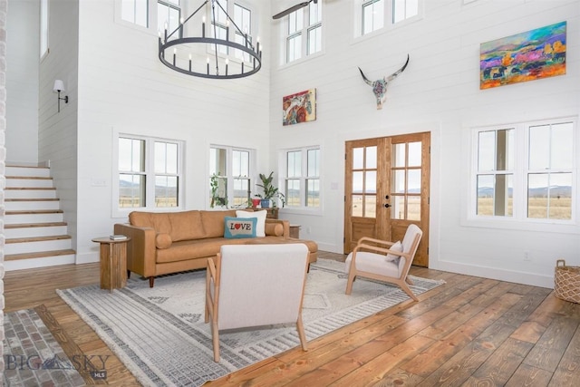 992 Deer Haven Dr, Deer Lodge, MT 59722 - living area with a towering ceiling, hardwood / wood-style floors, baseboards, stairs, and french doors