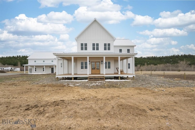 992 Deer Haven Dr, Deer Lodge, MT 59722 - view of front of property featuring french doors, board and batten siding, metal roof, and a porch
