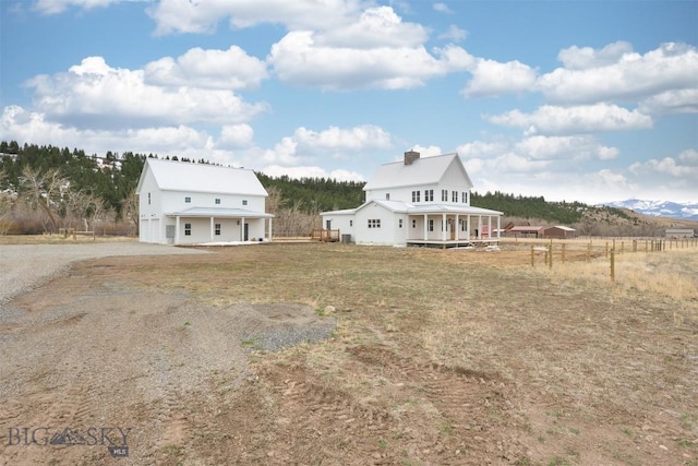 992 Deer Haven Dr, Deer Lodge, MT 59722 - rear view of house with a porch and driveway