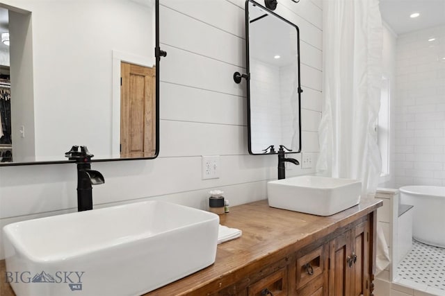 992 Deer Haven Dr, Deer Lodge, MT 59722 - bathroom featuring double vanity, a freestanding tub, and recessed lighting