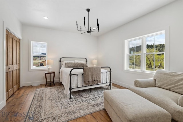 992 Deer Haven Dr, Deer Lodge, MT 59722 - bedroom with a chandelier, baseboards, wood finished floors, and recessed lighting