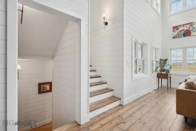 992 Deer Haven Dr, Deer Lodge, MT 59722 - staircase featuring hardwood / wood-style flooring and high vaulted ceiling