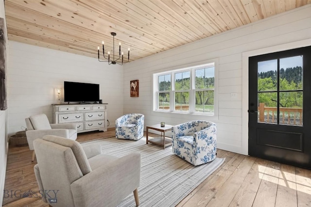 992 Deer Haven Dr, Deer Lodge, MT 59722 - living area featuring a chandelier, hardwood / wood-style floors, wooden walls, and wooden ceiling